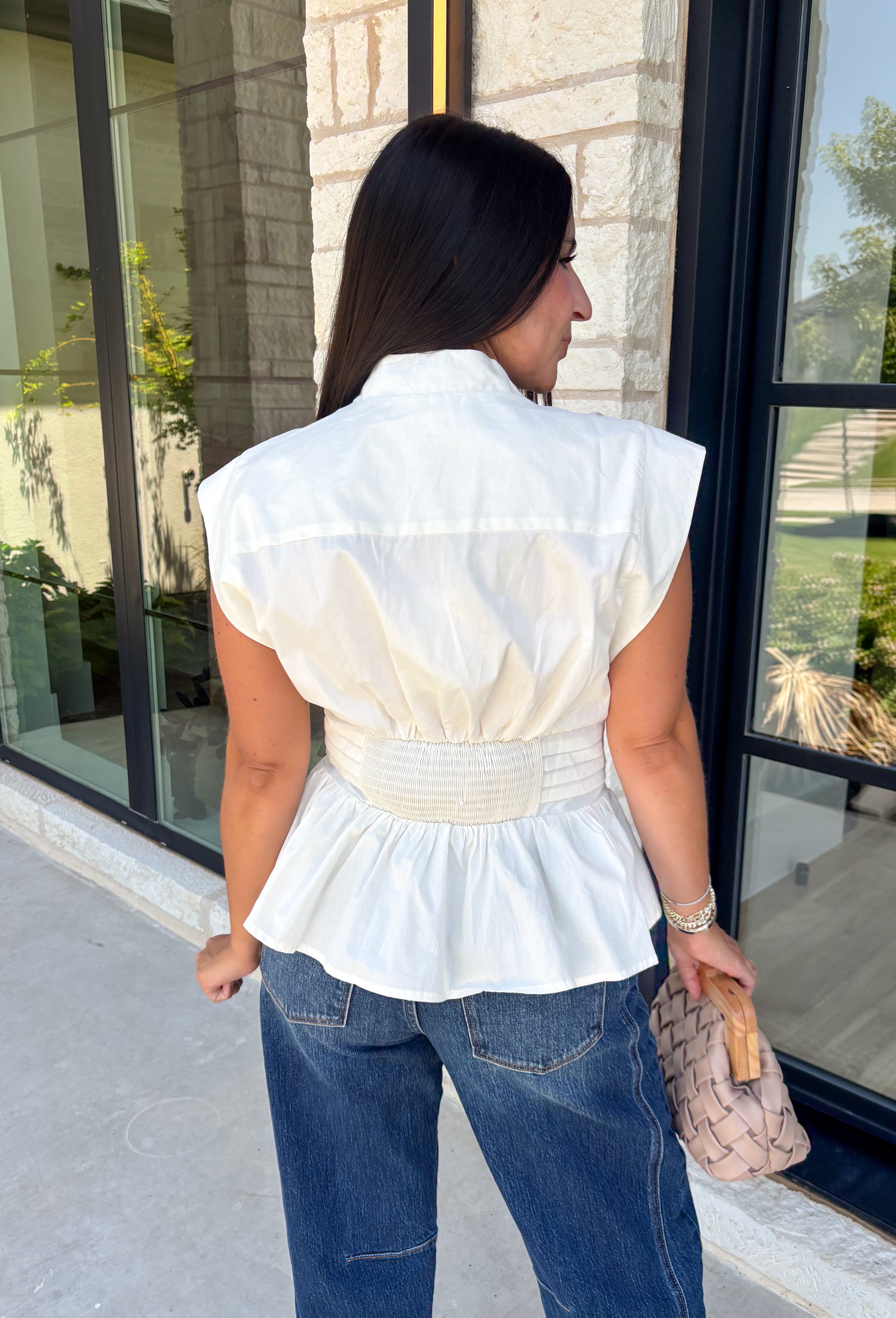 A timeless neutral is always in style, and this cream blouse is one you'll wear on repeat all season long! Designed with a flattering v-neckline and an adjustable self-tie waist, this feminine top creates a beautifully tailored silhouette with effortless comfort. The button front adds a polished touch, while the smocked elastic back offers a flexible, flattering fit. 