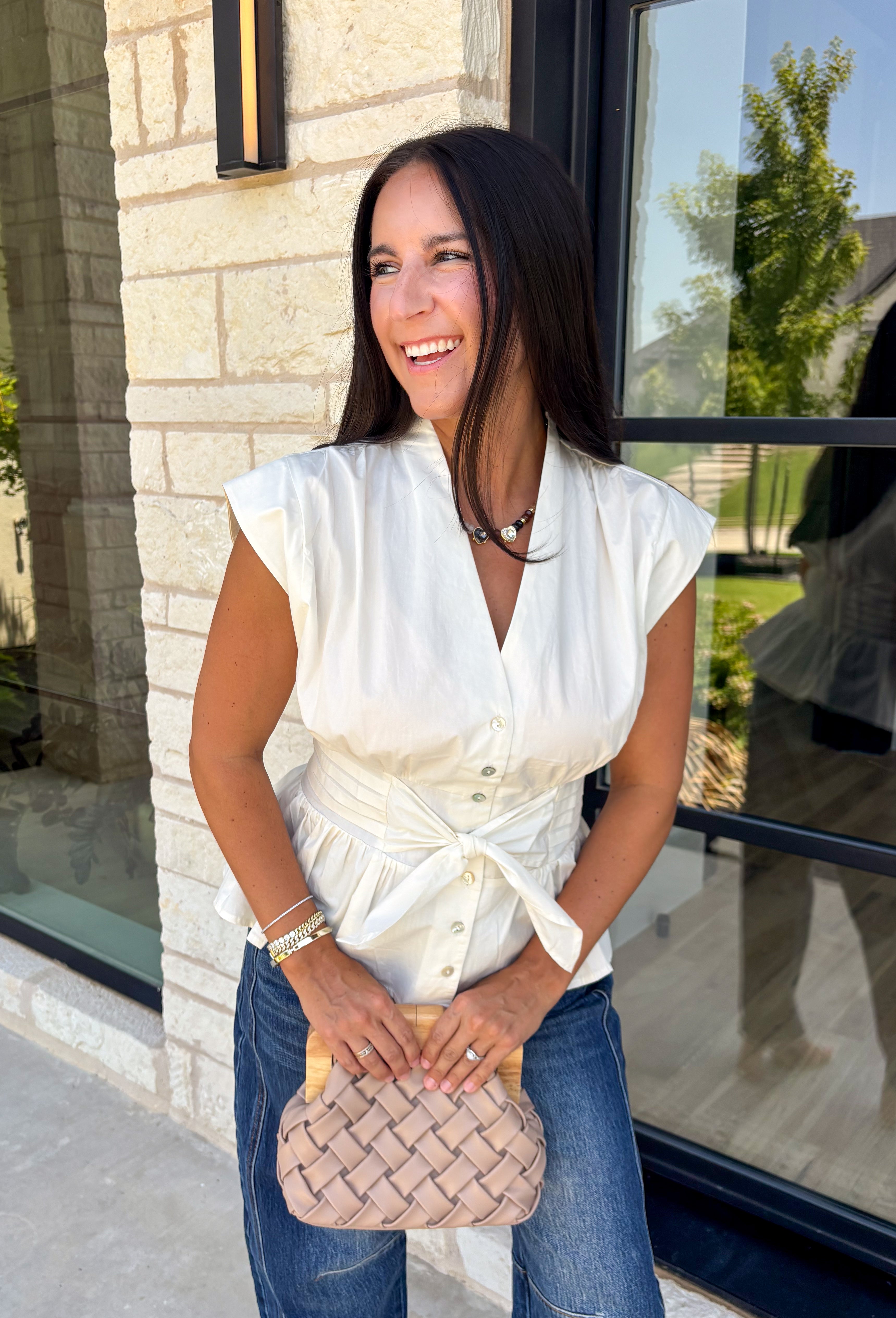 A timeless neutral is always in style, and this cream blouse is one you'll wear on repeat all season long! Designed with a flattering v-neckline and an adjustable self-tie waist, this feminine top creates a beautifully tailored silhouette with effortless comfort. The button front adds a polished touch, while the smocked elastic back offers a flexible, flattering fit. 