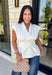 A timeless neutral is always in style, and this cream blouse is one you'll wear on repeat all season long! Designed with a flattering v-neckline and an adjustable self-tie waist, this feminine top creates a beautifully tailored silhouette with effortless comfort. The button front adds a polished touch, while the smocked elastic back offers a flexible, flattering fit. 