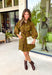 A timeless print meets effortless sophistication in this stunning long sleeve dress. Designed in a rich olive hue with a brown zebra print, this dress offers a fresh take on a classic fall look. The button-front design and matching self-tie belt create a flattering, customizable silhouette, while the soft ruffle neckline adds just the right touch of feminine charm. 
