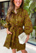 A timeless print meets effortless sophistication in this stunning long sleeve dress. Designed in a rich olive hue with a brown zebra print, this dress offers a fresh take on a classic fall look. The button-front design and matching self-tie belt create a flattering, customizable silhouette, while the soft ruffle neckline adds just the right touch of feminine charm. 