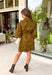 A timeless print meets effortless sophistication in this stunning long sleeve dress. Designed in a rich olive hue with a brown zebra print, this dress offers a fresh take on a classic fall look. The button-front design and matching self-tie belt create a flattering, customizable silhouette, while the soft ruffle neckline adds just the right touch of feminine charm. 