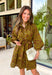 A timeless print meets effortless sophistication in this stunning long sleeve dress. Designed in a rich olive hue with a brown zebra print, this dress offers a fresh take on a classic fall look. The button-front design and matching self-tie belt create a flattering, customizable silhouette, while the soft ruffle neckline adds just the right touch of feminine charm. 