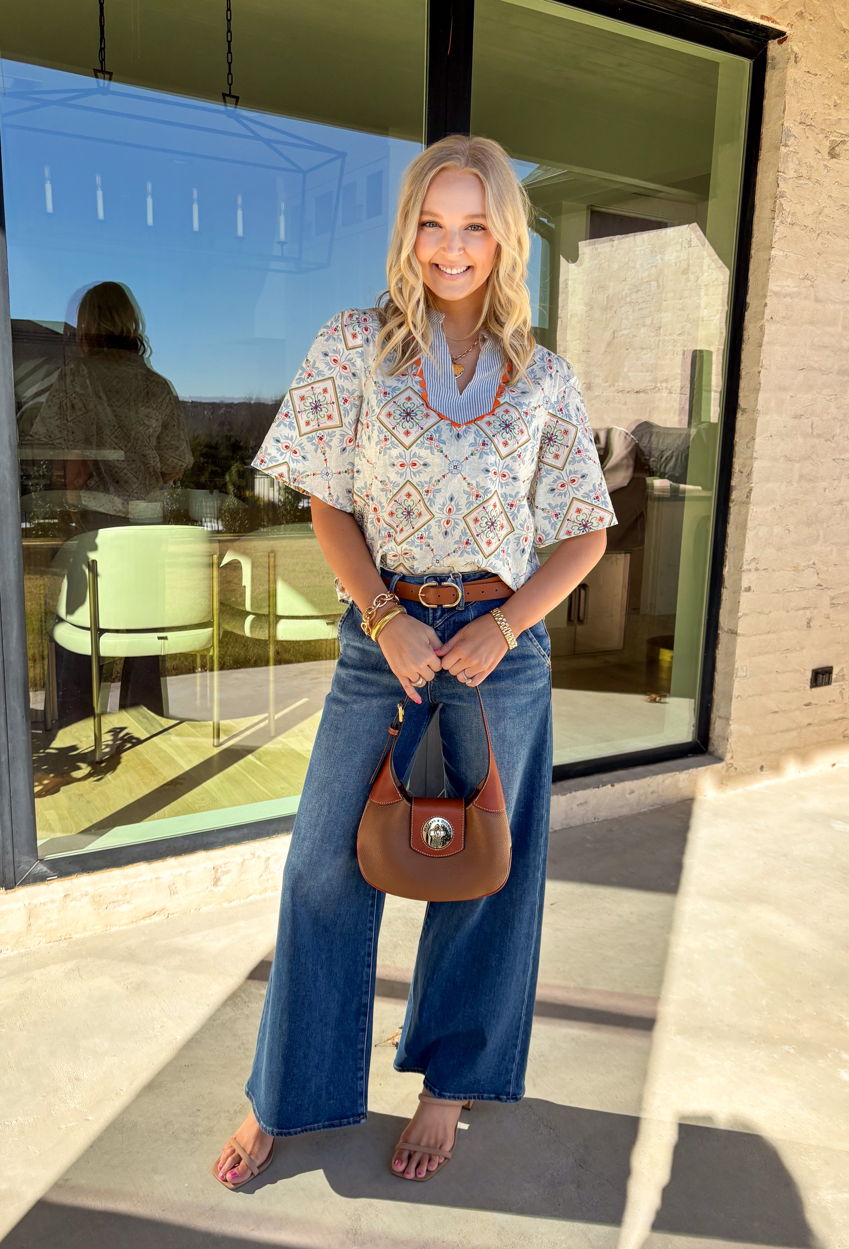 Bright, playful, and made for spring days, this off-white short sleeve top by Voy is an instant mood booster. Featuring a colorful floral print with pops of light blue, green, pink, and red, it brings the perfect burst of color to your everyday lineup. Light blue and white striped detailing along the top adds a fun contrast, while the orange rickrack trim gives it the cutest vintage-inspired finish. Made from breathable cotton, this top is easy to wear and effortless to style all season long.