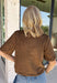 Elevate your autumn wardrobe with a top that's equal parts sophisticated and effortlessly wearable! Crafted from buttery-soft chocolate brown faux suede, this elevated piece brings rich texture and timeless style to any outfit. The standout gold horse bit details on the front pockets add an elegant equestrian-inspired touch, while the sleek back zipper closure creates a polished finish.