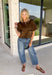 Elevate your autumn wardrobe with a top that's equal parts sophisticated and effortlessly wearable! Crafted from buttery-soft chocolate brown faux suede, this elevated piece brings rich texture and timeless style to any outfit. The standout gold horse bit details on the front pockets add an elegant equestrian-inspired touch, while the sleek back zipper closure creates a polished finish.