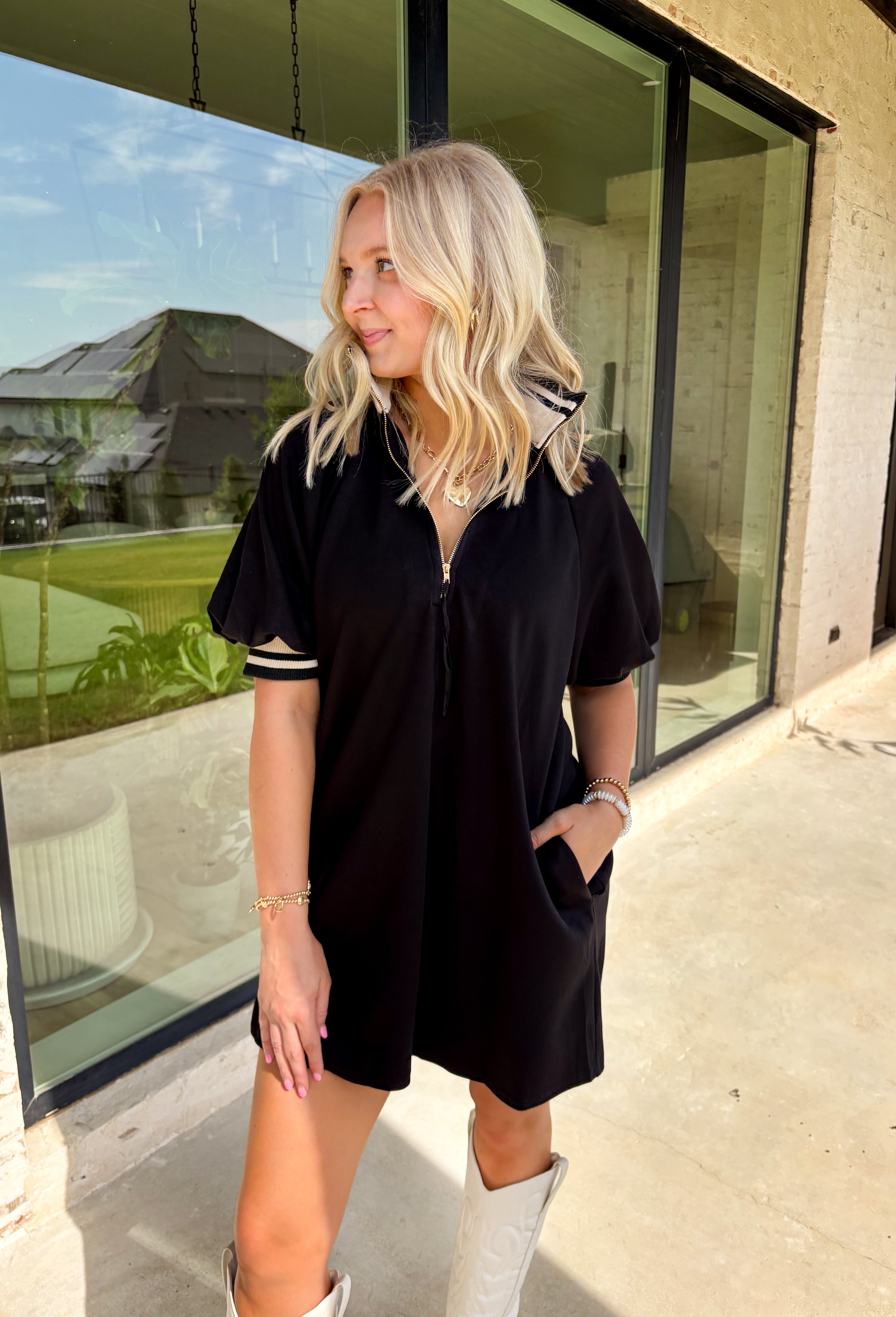 Sporty meets chic in this buttery soft black dress. Designed with a functional front zipper, it’s detailed with multicolor neutral ribbed trim that gives it a laid-back yet polished vibe. Side pockets make it as practical as it is stylish, and the soft, stretchy fabric ensures all-day comfort. Perfect for casual days out or dressed up with accessories for a more elevated look, this one-and-done piece is a true fall staple.