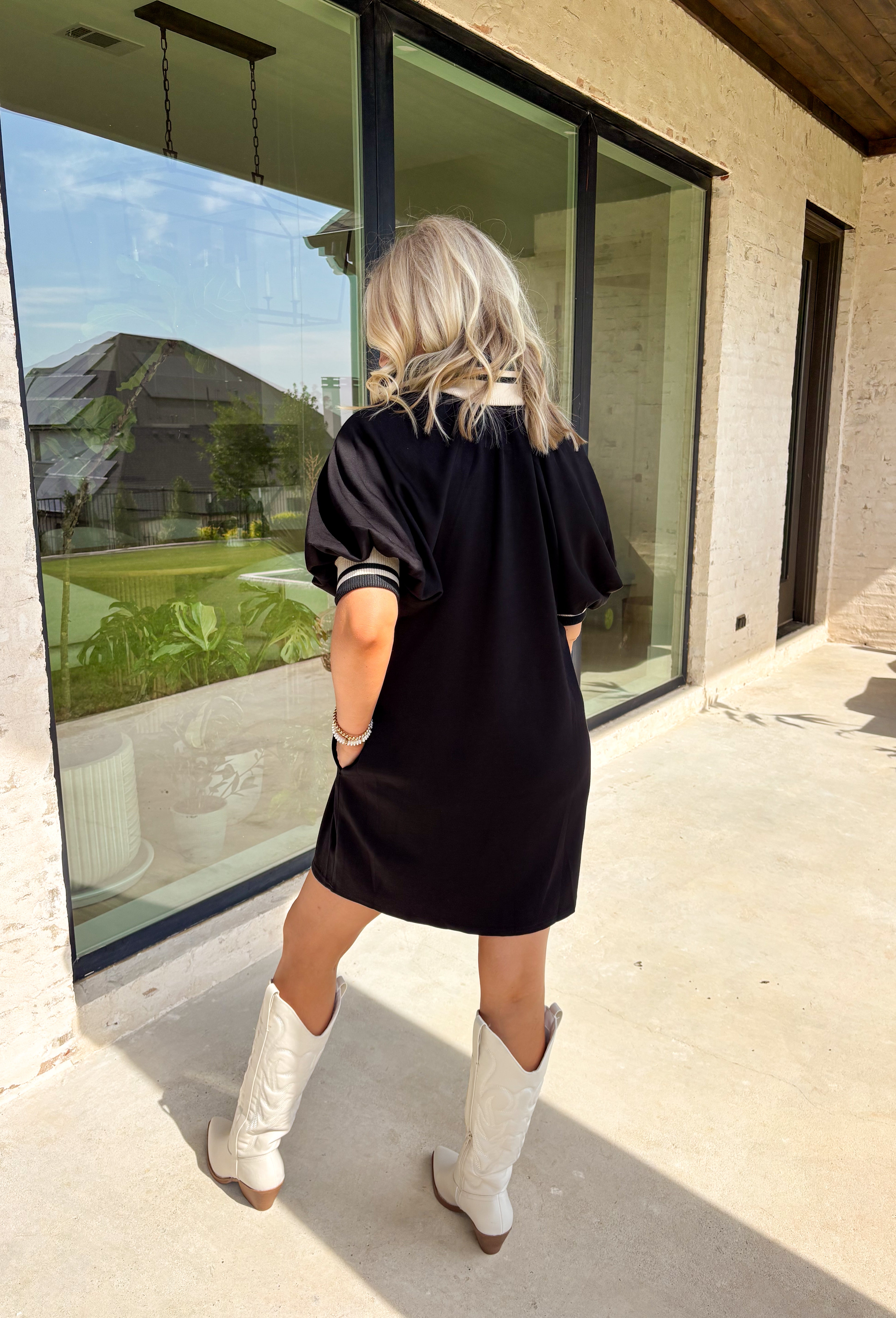 Sporty meets chic in this buttery soft black dress. Designed with a functional front zipper, it’s detailed with multicolor neutral ribbed trim that gives it a laid-back yet polished vibe. Side pockets make it as practical as it is stylish, and the soft, stretchy fabric ensures all-day comfort. Perfect for casual days out or dressed up with accessories for a more elevated look, this one-and-done piece is a true fall staple.