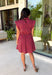 This striped dress brings together rich autumn colors and timeless style for a look you'll love all season long. Featuring brown and vibrant fuchsia stripes, it adds a fun pop of color while still feeling perfectly fall-ready. The front button closure and flattering waist tie create a polished silhouette, while the elastic back waist offers a comfortable fit you'll appreciate from morning to night. Finished with cap sleeves, side pockets, and a fully lined design.