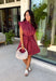 This striped dress brings together rich autumn colors and timeless style for a look you'll love all season long. Featuring brown and vibrant fuchsia stripes, it adds a fun pop of color while still feeling perfectly fall-ready. The front button closure and flattering waist tie create a polished silhouette, while the elastic back waist offers a comfortable fit you'll appreciate from morning to night. Finished with cap sleeves, side pockets, and a fully lined design.