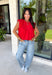 Bring a rich pop of autumn color to your wardrobe with this effortlessly chic red knit top! Designed with a softly gathered round neckline and an elastic hem, it creates a flattering silhouette that's both comfortable and polished. The cap sleeves make it perfect for layering under cardigans, blazers, or denim jackets as the temperatures begin to cool, while the buttery-soft knit fabric makes it one you'll want to wear on repeat. 