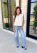 Say hello to your new favorite neutral top! Designed with a softly gathered round neckline and an elastic hem, it creates a flattering silhouette that's both comfortable and polished. The cap sleeves make it perfect for layering under cardigans, blazers, or denim jackets as the temperatures begin to cool, while the buttery-soft knit fabric makes it one you'll want to wear on repeat.