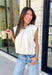Say hello to your new favorite neutral top! Designed with a softly gathered round neckline and an elastic hem, it creates a flattering silhouette that's both comfortable and polished. The cap sleeves make it perfect for layering under cardigans, blazers, or denim jackets as the temperatures begin to cool, while the buttery-soft knit fabric makes it one you'll want to wear on repeat.