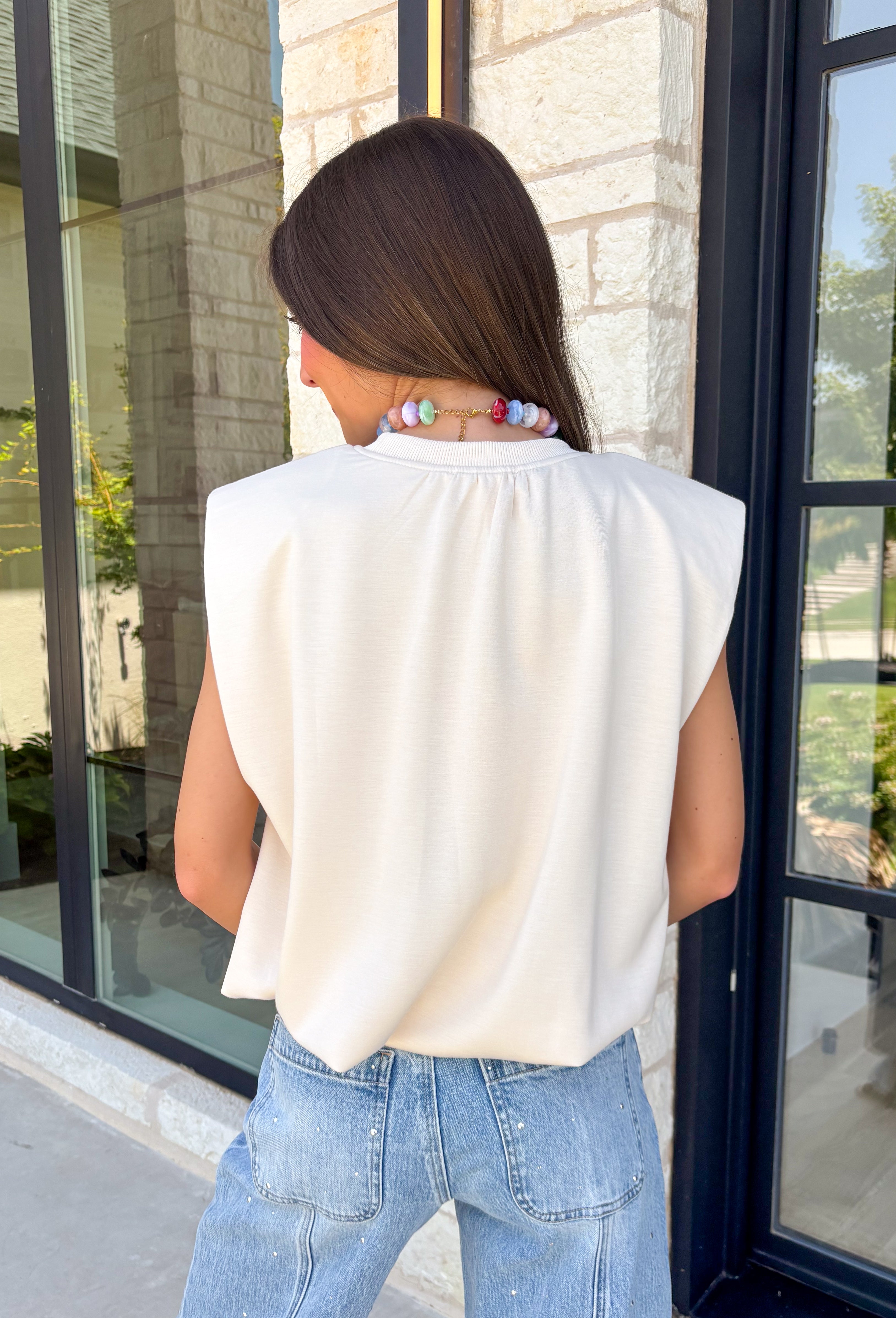Say hello to your new favorite neutral top! Designed with a softly gathered round neckline and an elastic hem, it creates a flattering silhouette that's both comfortable and polished. The cap sleeves make it perfect for layering under cardigans, blazers, or denim jackets as the temperatures begin to cool, while the buttery-soft knit fabric makes it one you'll want to wear on repeat.