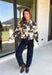 Add a little western-inspired flair to your layering collection with this standout denim jacket from Entro. Designed with a striking cream and black cowhide-inspired print, this timeless piece brings the perfect mix of classic denim styling and bold personality. The collared neckline and button-front closure create a polished, everyday look, while the front pockets add both style and function.