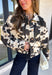 Add a little western-inspired flair to your layering collection with this standout denim jacket from Entro. Designed with a striking cream and black cowhide-inspired print, this timeless piece brings the perfect mix of classic denim styling and bold personality. The collared neckline and button-front closure create a polished, everyday look, while the front pockets add both style and function.