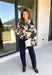 Add a little western-inspired flair to your layering collection with this standout denim jacket from Entro. Designed with a striking cream and black cowhide-inspired print, this timeless piece brings the perfect mix of classic denim styling and bold personality. The collared neckline and button-front closure create a polished, everyday look, while the front pockets add both style and function.