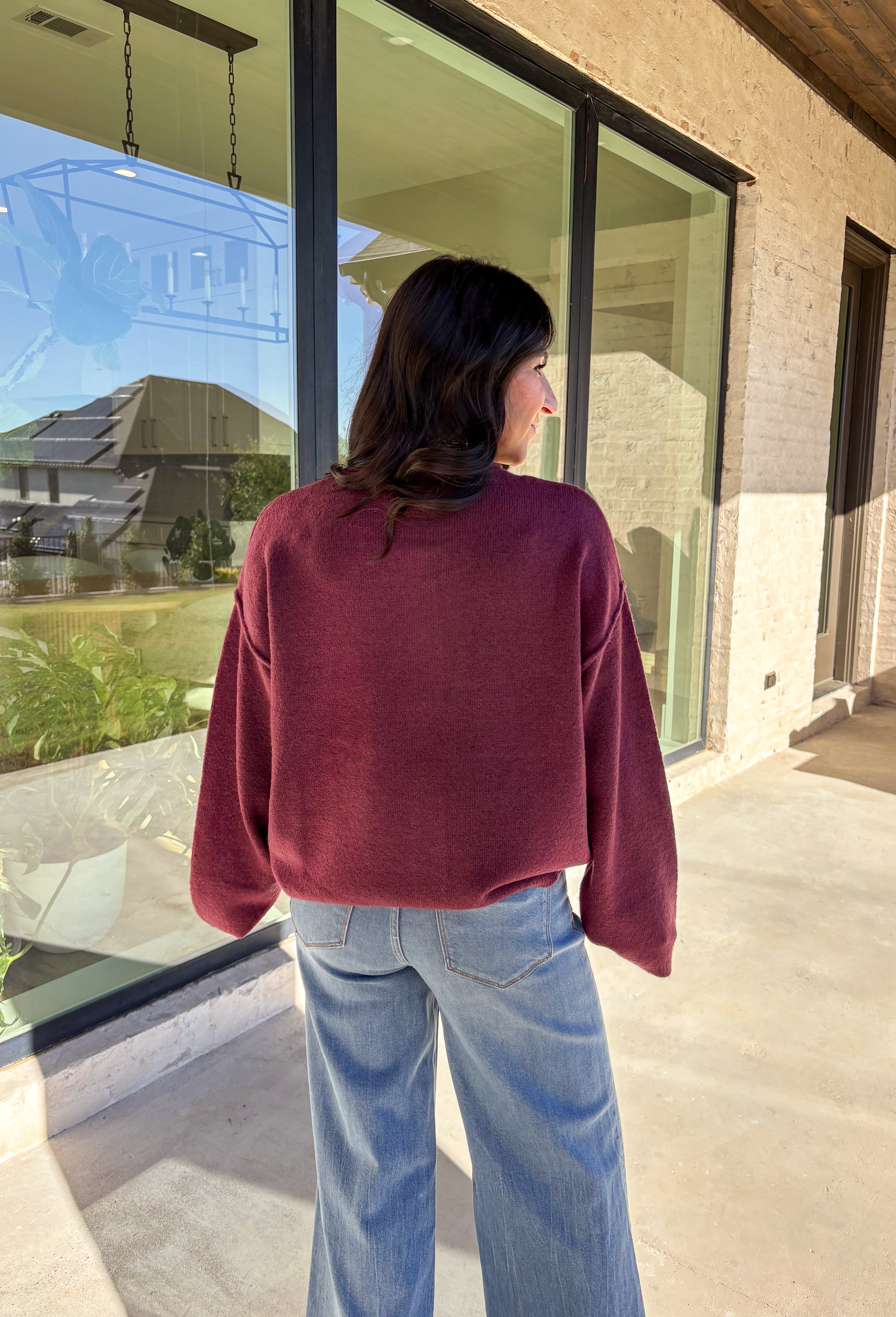This burgundy button-down cardigan by Double Zero is the ultimate cozy classic. The soft knit fabric and rich fall hue make it an effortless layering piece for cooler days. Whether you’re dressing it up with a blouse or keeping it casual with jeans and a tee, this timeless cardigan adds warmth and style to any outfit.
