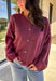 This burgundy button-down cardigan by Double Zero is the ultimate cozy classic. The soft knit fabric and rich fall hue make it an effortless layering piece for cooler days. Whether you’re dressing it up with a blouse or keeping it casual with jeans and a tee, this timeless cardigan adds warmth and style to any outfit.