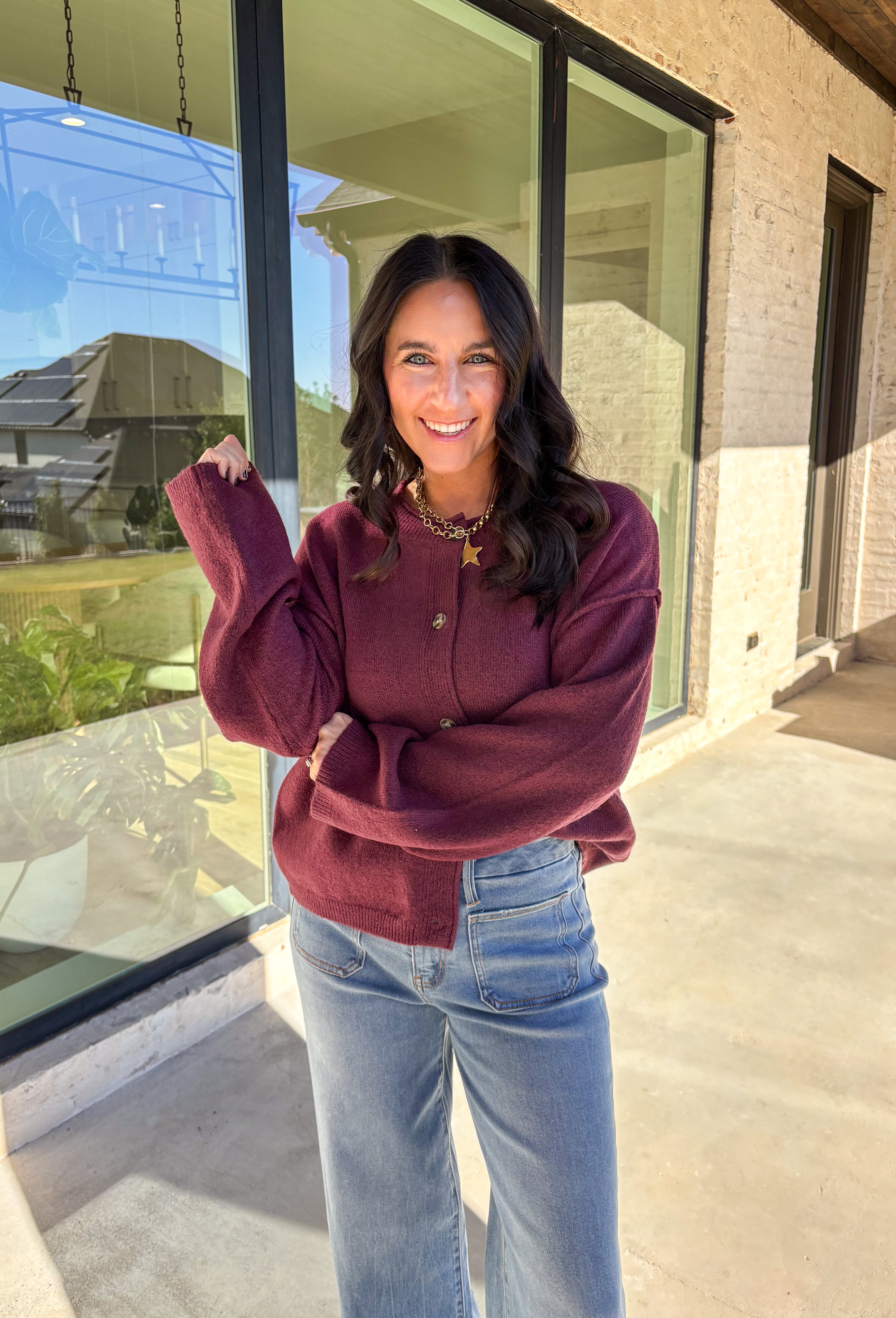 This burgundy button-down cardigan by Double Zero is the ultimate cozy classic. The soft knit fabric and rich fall hue make it an effortless layering piece for cooler days. Whether you’re dressing it up with a blouse or keeping it casual with jeans and a tee, this timeless cardigan adds warmth and style to any outfit.