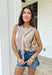 Effortlessly chic with a “styled in two seconds” kind of vibe, this tan sleeveless top by Entro gives you that layered look without any extra work. Designed to look like a lightweight sweater is draped around the neckline, it creates an elevated, put-together feel while still being super easy to wear. The sleeveless silhouette keeps it spring-friendly, and the soft knit blend makes it perfect for layering now and wearing solo as the weather warms up.