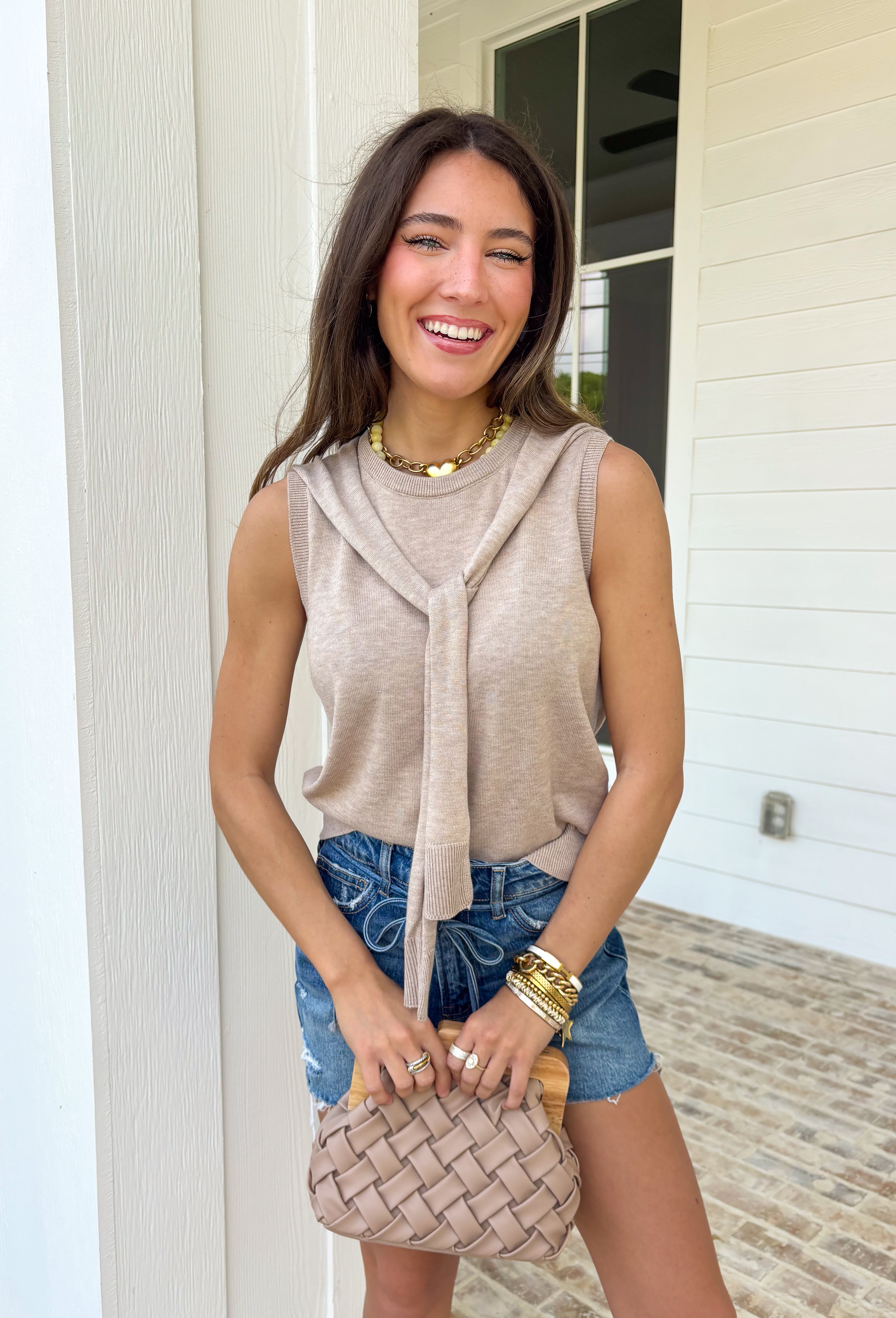 Effortlessly chic with a “styled in two seconds” kind of vibe, this tan sleeveless top by Entro gives you that layered look without any extra work. Designed to look like a lightweight sweater is draped around the neckline, it creates an elevated, put-together feel while still being super easy to wear. The sleeveless silhouette keeps it spring-friendly, and the soft knit blend makes it perfect for layering now and wearing solo as the weather warms up.