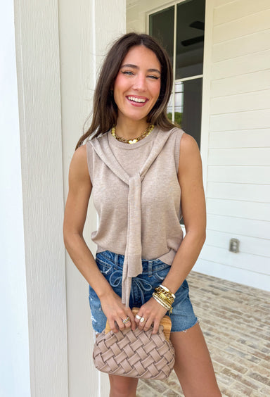 Effortlessly chic with a “styled in two seconds” kind of vibe, this tan sleeveless top by Entro gives you that layered look without any extra work. Designed to look like a lightweight sweater is draped around the neckline, it creates an elevated, put-together feel while still being super easy to wear. The sleeveless silhouette keeps it spring-friendly, and the soft knit blend makes it perfect for layering now and wearing solo as the weather warms up.