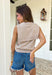 Effortlessly chic with a “styled in two seconds” kind of vibe, this tan sleeveless top by Entro gives you that layered look without any extra work. Designed to look like a lightweight sweater is draped around the neckline, it creates an elevated, put-together feel while still being super easy to wear. The sleeveless silhouette keeps it spring-friendly, and the soft knit blend makes it perfect for layering now and wearing solo as the weather warms up.