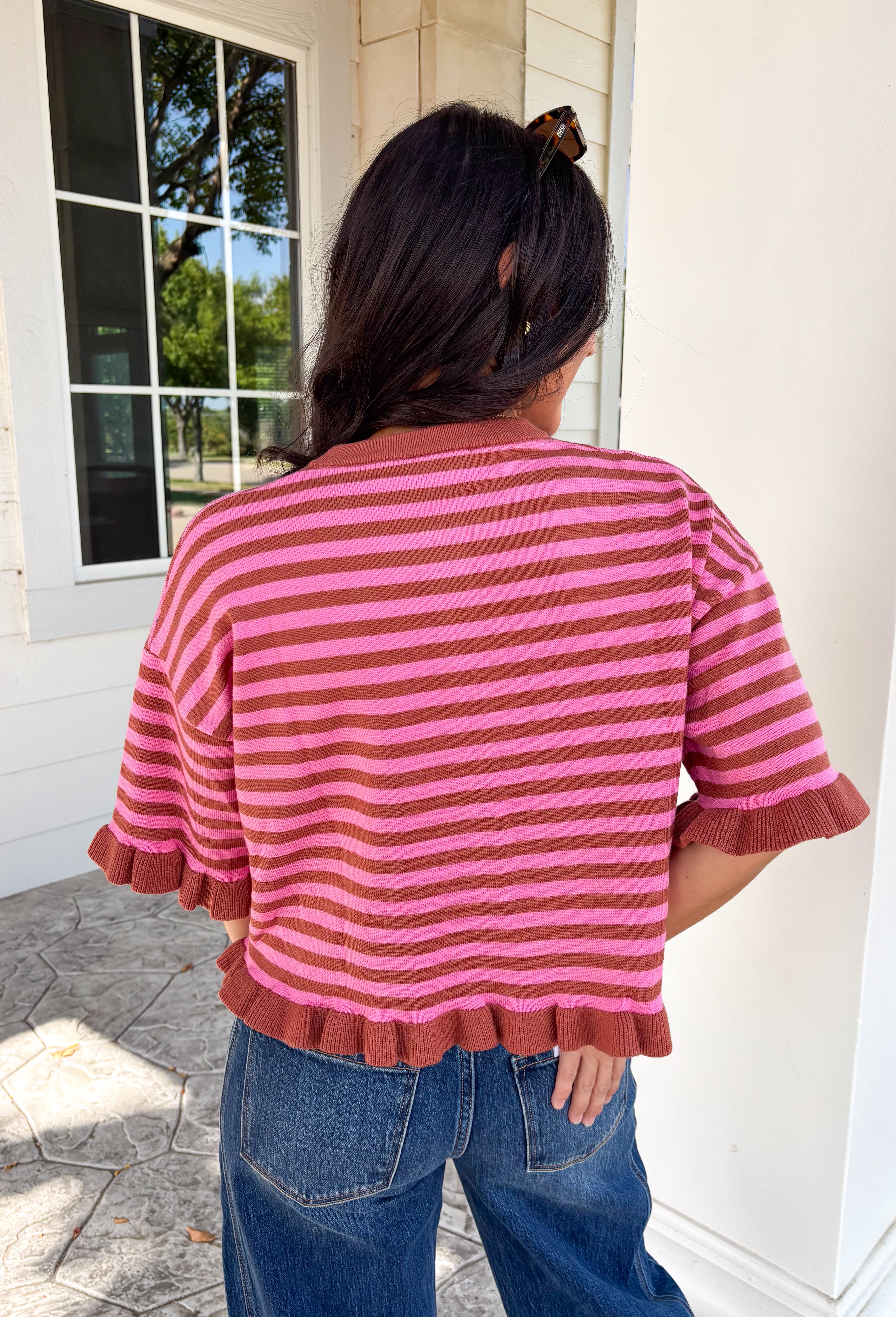 Sweet details and rich fall colors make this knit cardigan an instant favorite. Featuring warm brown and pink stripes, this lightweight cardigan brings the perfect touch of cozy charm to your autumn wardrobe. The ruffle trim on the sleeves and hem adds a feminine finish, while the button-down front lets you wear it as a cardigan or buttoned up as a sweater. It's the perfect transitional knit for everything from office days to weekend coffee runs and crisp fall afternoons.