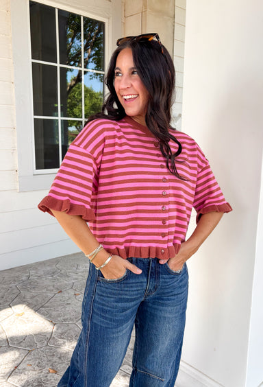 Sweet details and rich fall colors make this knit cardigan an instant favorite. Featuring warm brown and pink stripes, this lightweight cardigan brings the perfect touch of cozy charm to your autumn wardrobe. The ruffle trim on the sleeves and hem adds a feminine finish, while the button-down front lets you wear it as a cardigan or buttoned up as a sweater. It's the perfect transitional knit for everything from office days to weekend coffee runs and crisp fall afternoons.