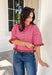 Sweet details and rich fall colors make this knit cardigan an instant favorite. Featuring warm brown and pink stripes, this lightweight cardigan brings the perfect touch of cozy charm to your autumn wardrobe. The ruffle trim on the sleeves and hem adds a feminine finish, while the button-down front lets you wear it as a cardigan or buttoned up as a sweater. It's the perfect transitional knit for everything from office days to weekend coffee runs and crisp fall afternoons.