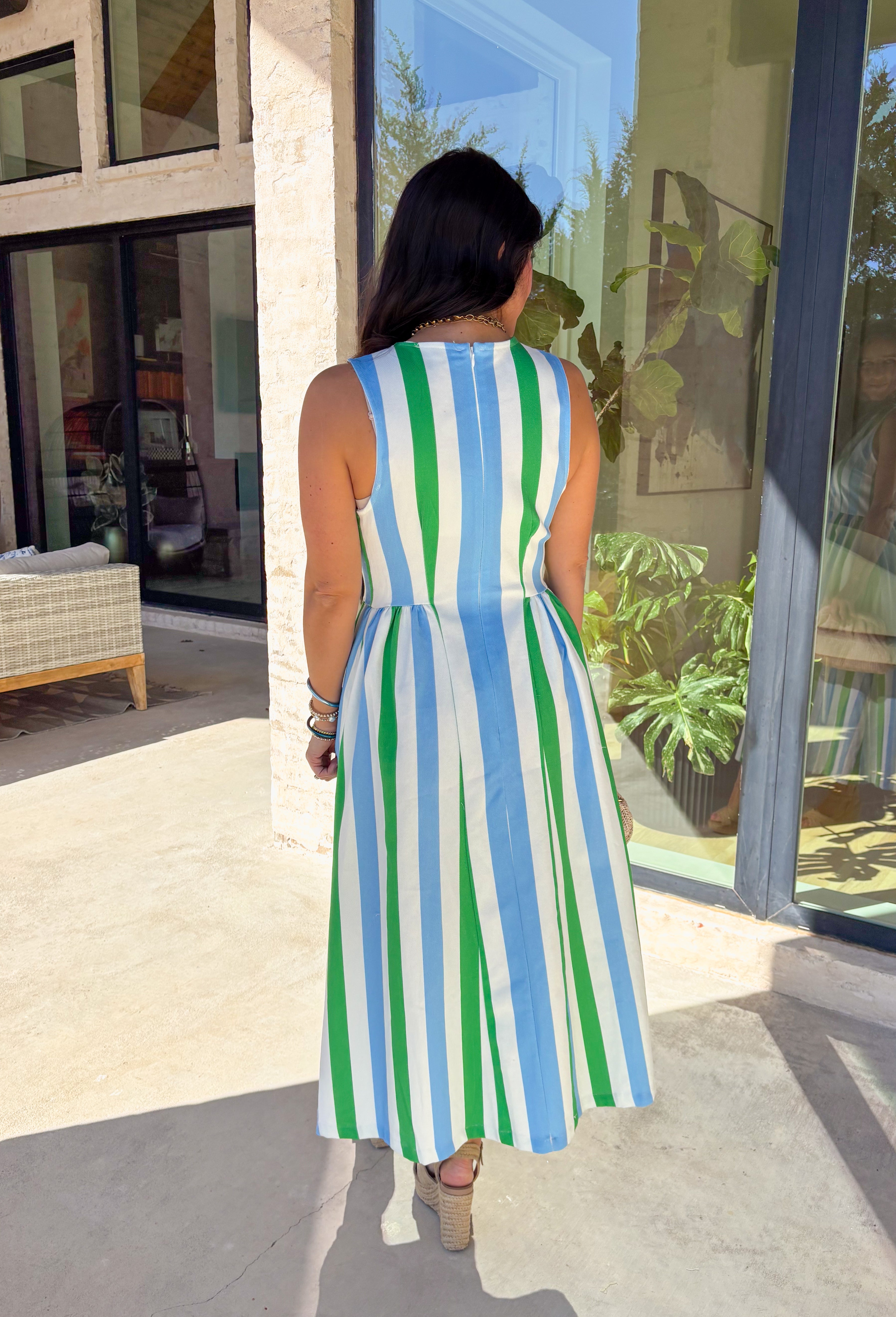Say hello to your new warm-weather go-to! This off white, light blue, and green striped midi dress by Entro is the definition of easy spring style—sweet, simple, and effortlessly polished. The sleeveless silhouette keeps it breezy for sunny days, while the midi length gives you that “cute but comfortable” vibe you can wear anywhere. Finished with a clean back zipper closure, you'll find yourself reaching for this dress all season long!