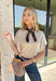 Simple, timeless, and elevated with just the right amount of detail, this ecru knit top is a fall wardrobe essential! Crafted from a soft, lightweight knit, this versatile piece features chic grommet detailing on the sleeves for a modern touch that sets it apart. The classic round neckline makes it easy to style with everything from your favorite denim to tailored trousers, while the cozy feel keeps it comfortable all day long.