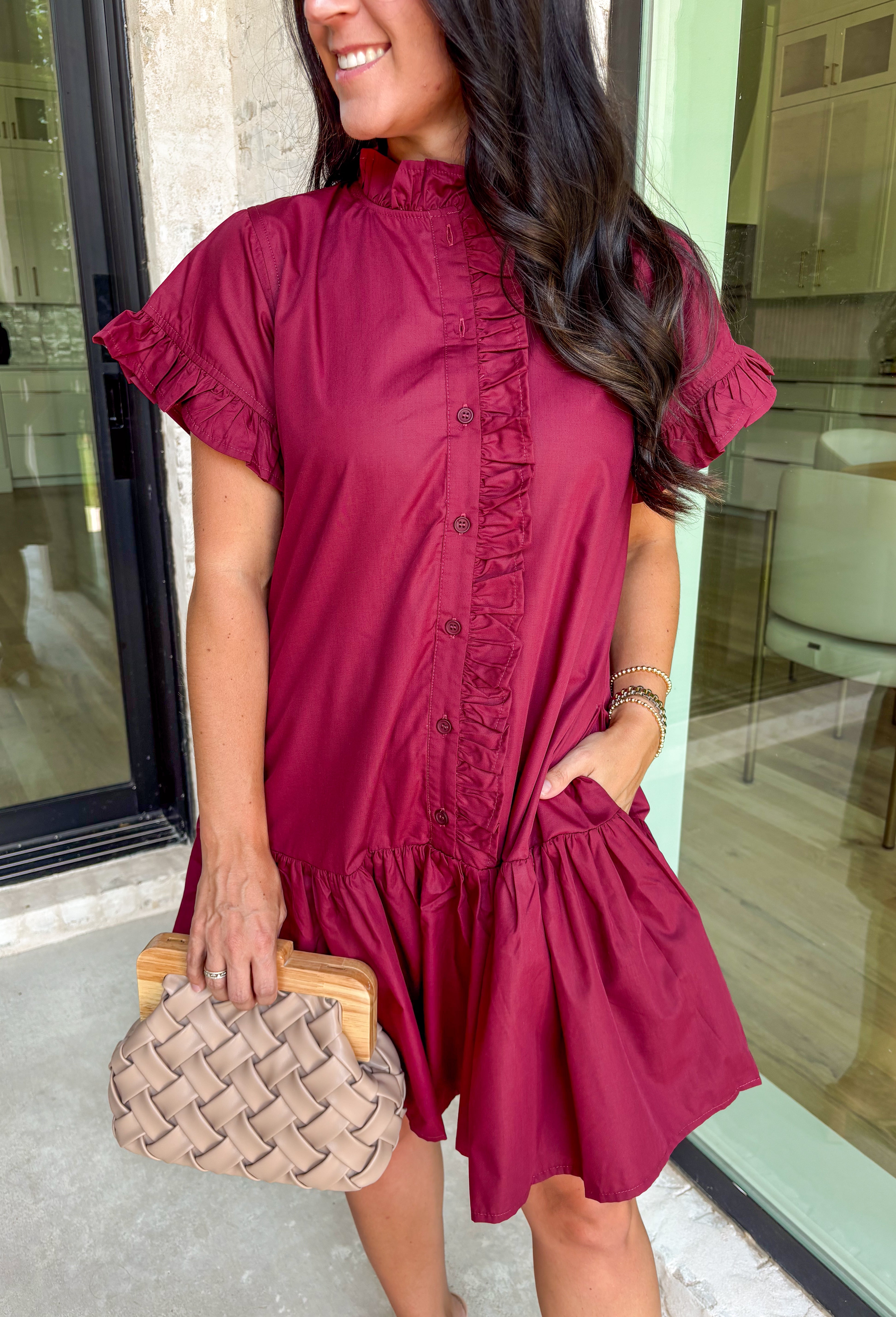 This burgundy ruffle mini dress is giving effortless charm with a touch of flirty flair. The playful ruffle hem and dainty button-front detail add just the right amount of movement, while side pockets keep it practical (because we all love a good pocket moment). Whether you’re headed to a fall brunch or layering it with boots and a denim jacket, this dress is a go-to for cozy and cute autumn style.