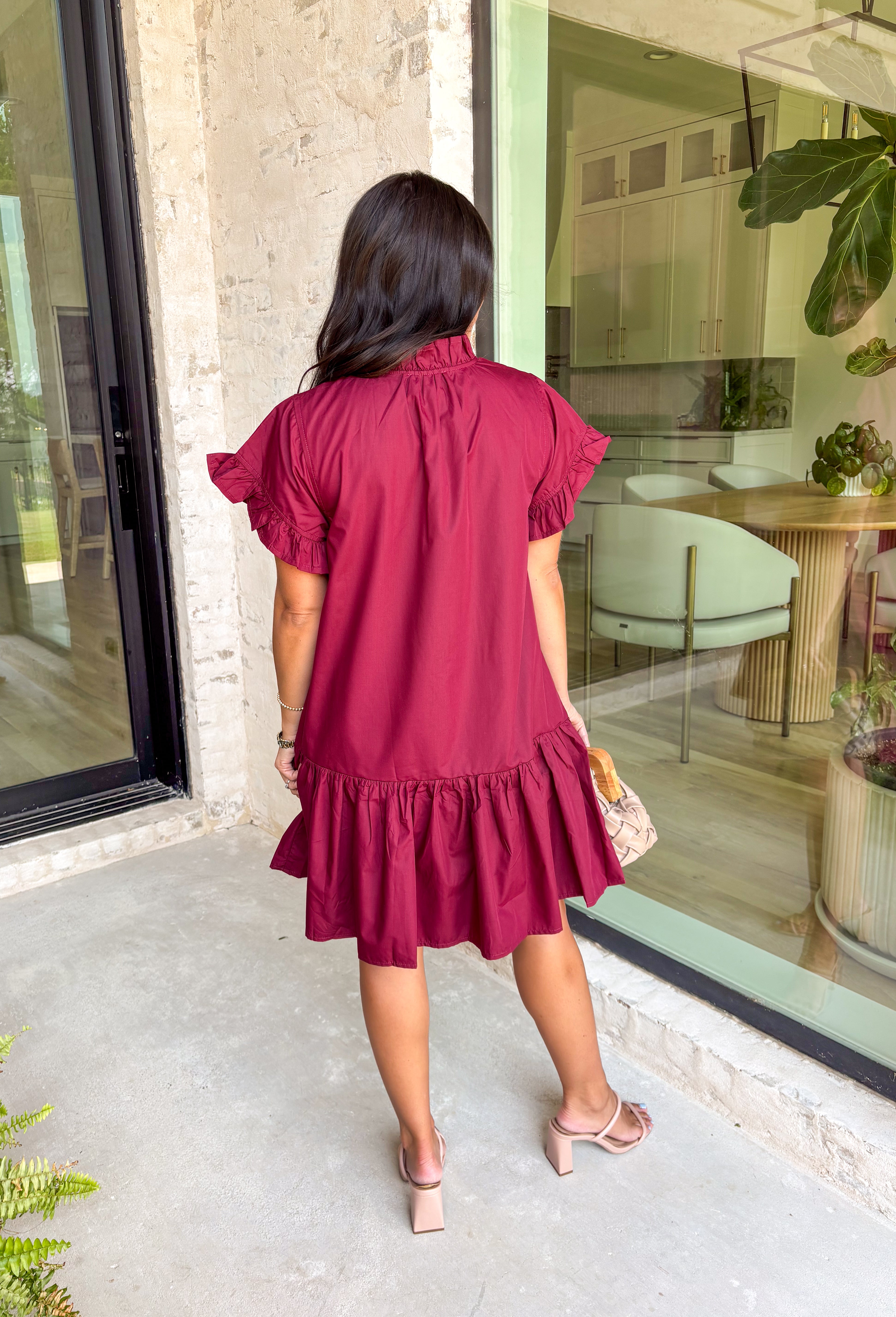 This burgundy ruffle mini dress is giving effortless charm with a touch of flirty flair. The playful ruffle hem and dainty button-front detail add just the right amount of movement, while side pockets keep it practical (because we all love a good pocket moment). Whether you’re headed to a fall brunch or layering it with boots and a denim jacket, this dress is a go-to for cozy and cute autumn style.