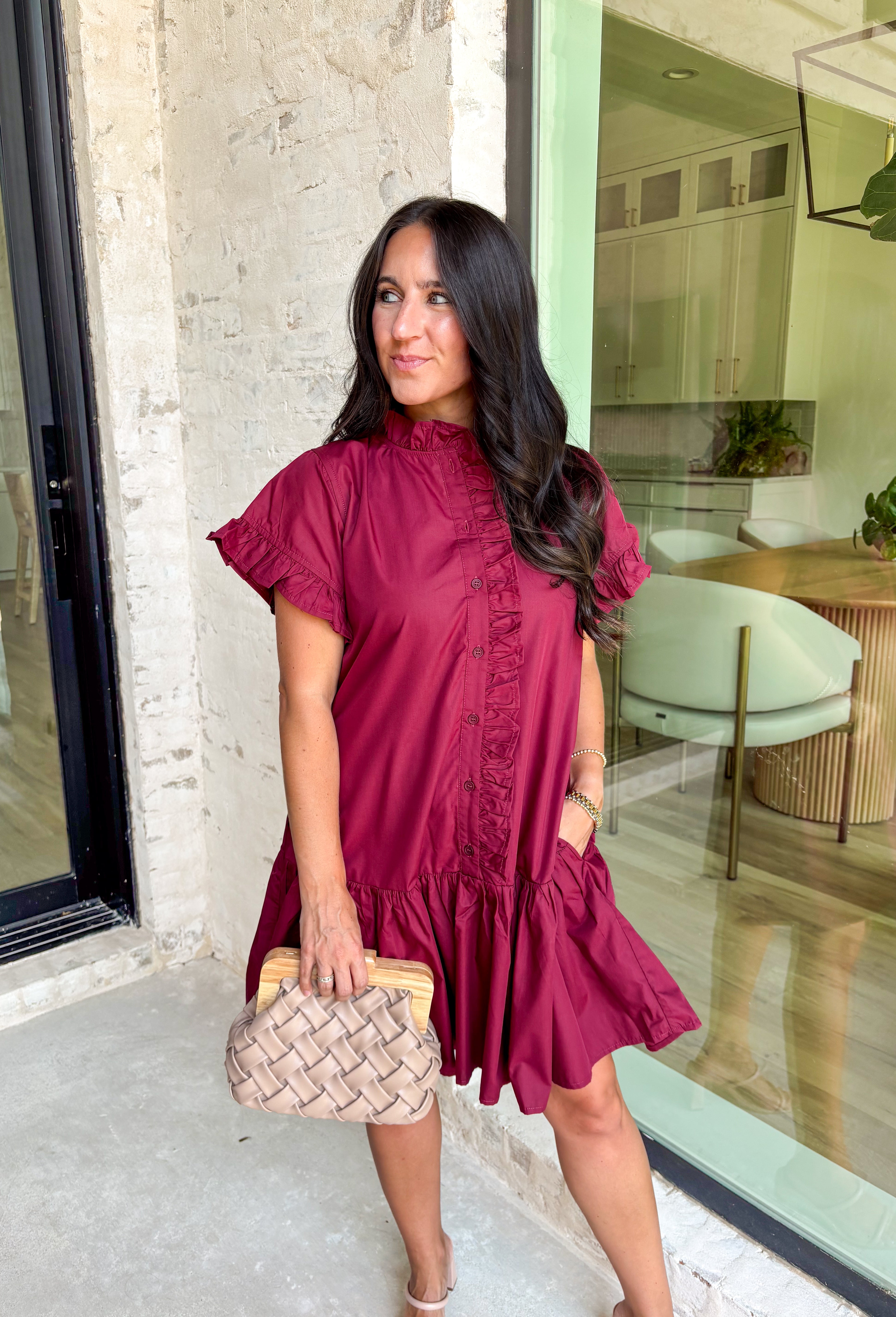 This burgundy ruffle mini dress is giving effortless charm with a touch of flirty flair. The playful ruffle hem and dainty button-front detail add just the right amount of movement, while side pockets keep it practical (because we all love a good pocket moment). Whether you’re headed to a fall brunch or layering it with boots and a denim jacket, this dress is a go-to for cozy and cute autumn style.