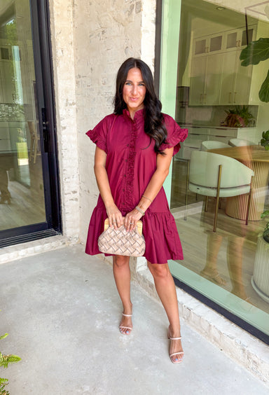 This burgundy ruffle mini dress is giving effortless charm with a touch of flirty flair. The playful ruffle hem and dainty button-front detail add just the right amount of movement, while side pockets keep it practical (because we all love a good pocket moment). Whether you’re headed to a fall brunch or layering it with boots and a denim jacket, this dress is a go-to for cozy and cute autumn style.