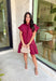 This burgundy ruffle mini dress is giving effortless charm with a touch of flirty flair. The playful ruffle hem and dainty button-front detail add just the right amount of movement, while side pockets keep it practical (because we all love a good pocket moment). Whether you’re headed to a fall brunch or layering it with boots and a denim jacket, this dress is a go-to for cozy and cute autumn style.