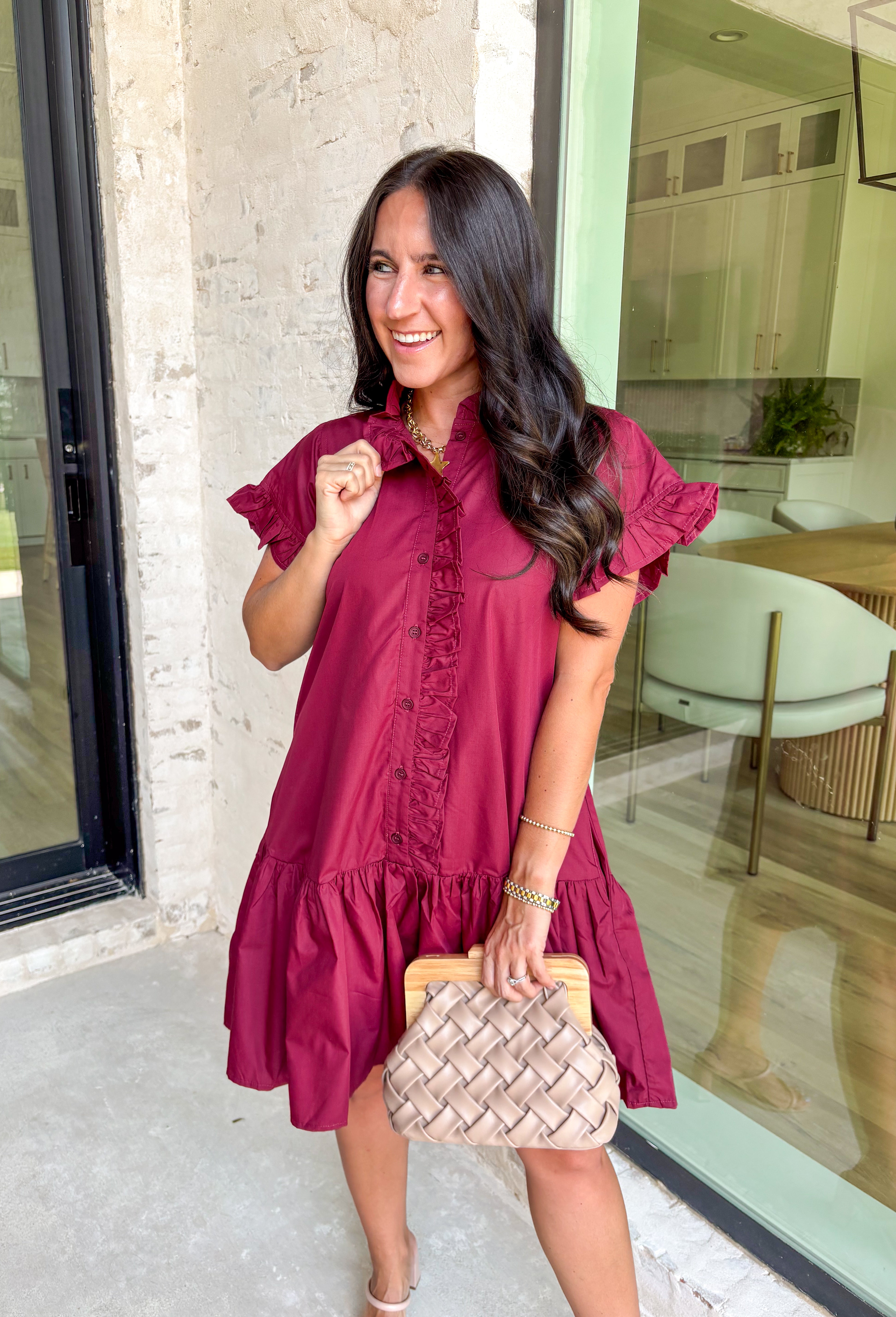 This burgundy ruffle mini dress is giving effortless charm with a touch of flirty flair. The playful ruffle hem and dainty button-front detail add just the right amount of movement, while side pockets keep it practical (because we all love a good pocket moment). Whether you’re headed to a fall brunch or layering it with boots and a denim jacket, this dress is a go-to for cozy and cute autumn style.