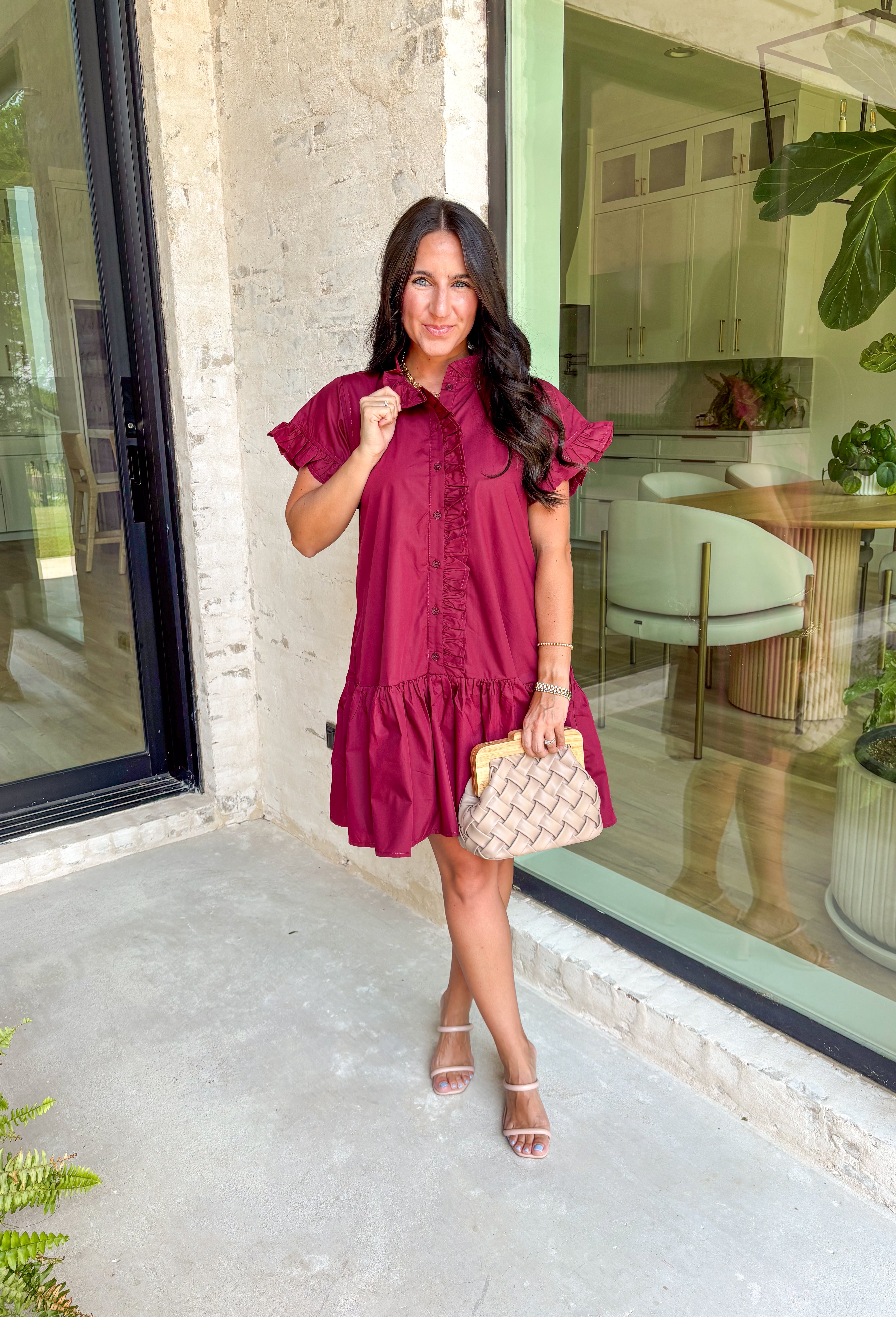 This burgundy ruffle mini dress is giving effortless charm with a touch of flirty flair. The playful ruffle hem and dainty button-front detail add just the right amount of movement, while side pockets keep it practical (because we all love a good pocket moment). Whether you’re headed to a fall brunch or layering it with boots and a denim jacket, this dress is a go-to for cozy and cute autumn style.