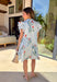 Fresh, playful, and full of spring charm, this button-down dress by Entro is a standout piece for the season. Featuring a classic blue and white stripe base with colorful floral prints layered throughout, it strikes the perfect balance between timeless and fun. Flutter sleeves add soft movement, while scalloped accent trim along the edges gives it a sweet, polished finish. Fully lined and made from breathable cotton, this dress is easy, comfortable, and perfect for sunny days ahead.