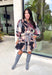 Celebrate the beauty of the season in this stunning eyelet dress from Entro. Designed in a gorgeous fall-inspired print featuring shades of black, brown, tan, gray, off-white, and a subtle pop of pink, this timeless dress is full of feminine charm. Delicate eyelet detailing adds beautiful texture, while the decorative front button accents and matching self-tie belt create a polished, flattering silhouette. 
