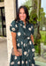 Timeless style meets effortless charm in this beautiful polka dot midi dress. Featuring a rich hunter green backdrop with a bold neutral polka dot print, this classic silhouette is one you'll love wearing year after year. The button-front design and adjustable self-tie waist create a flattering, feminine fit, while the puff sleeves add just the right amount of romantic detail. Complete with side pockets and a fully lined design, this cotton dress is as practical as it is polished.