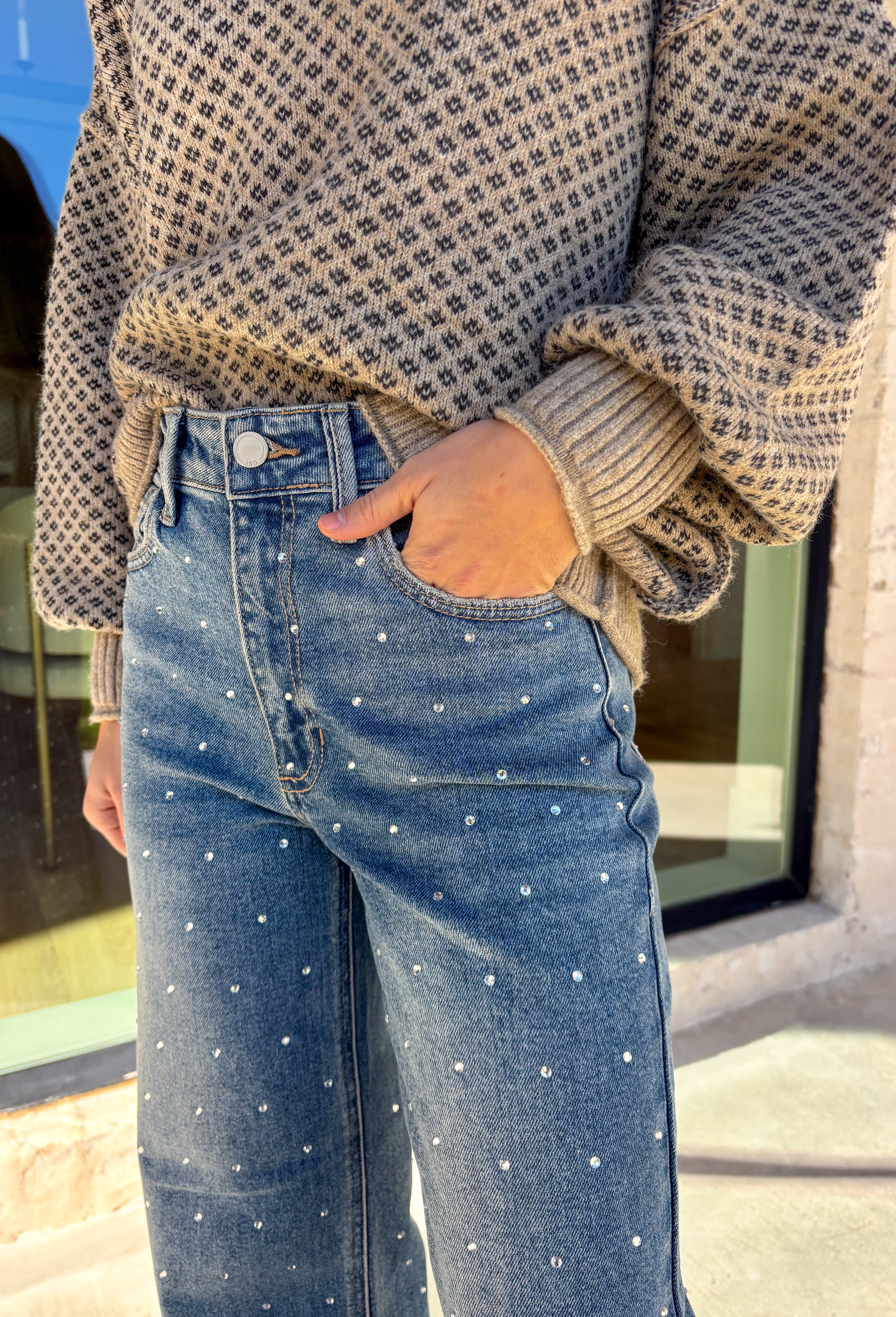 Make your winter wardrobe shine with these statement-making straight jeans by Just Black Denim. Designed in a classic medium wash with a flattering high rise, these standout denim gems are covered in silver rhinestones from front to back for the perfect touch of sparkle. With a structured yet comfortable fit, they’re ready for holiday parties, festive nights out, or whenever you want to turn heads.