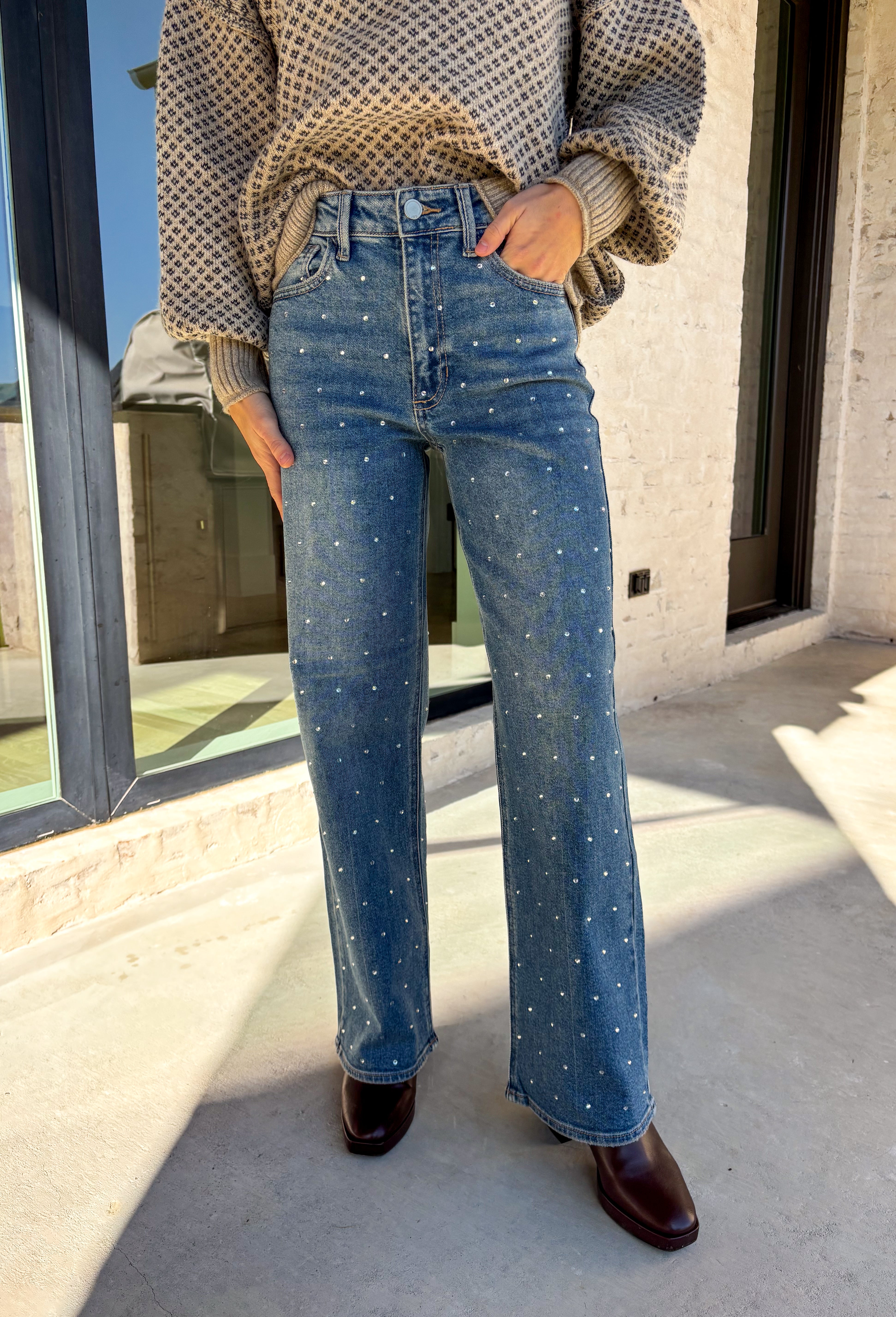 Make your winter wardrobe shine with these statement-making straight jeans by Just Black Denim. Designed in a classic medium wash with a flattering high rise, these standout denim gems are covered in silver rhinestones from front to back for the perfect touch of sparkle. With a structured yet comfortable fit, they’re ready for holiday parties, festive nights out, or whenever you want to turn heads.