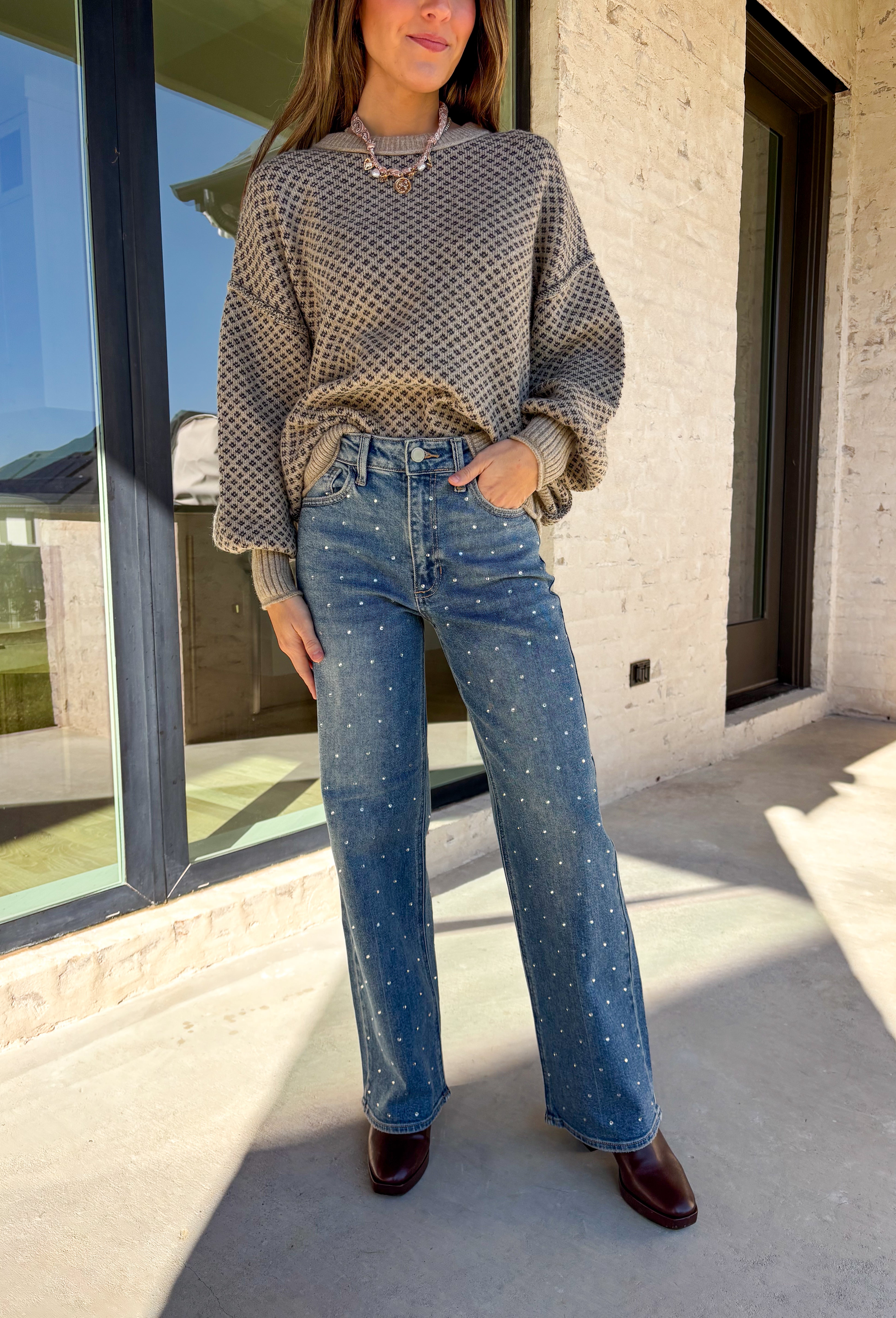 Make your winter wardrobe shine with these statement-making straight jeans by Just Black Denim. Designed in a classic medium wash with a flattering high rise, these standout denim gems are covered in silver rhinestones from front to back for the perfect touch of sparkle. With a structured yet comfortable fit, they’re ready for holiday parties, festive nights out, or whenever you want to turn heads.