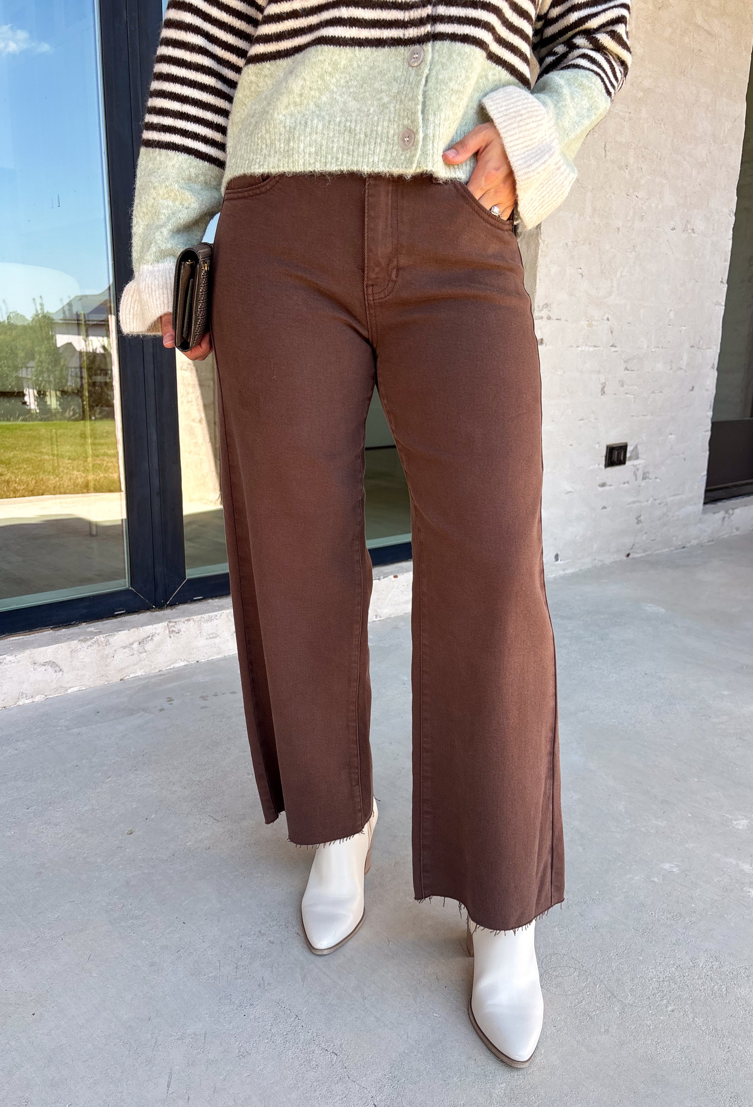 These chocolate brown jeans from Just Black Denim are the perfect blend of timeless style and everyday versatility. Designed with a flattering slim wide leg silhouette, they create an effortlessly elevated look that's easy to dress up or down. The rich chocolate brown color offers a fresh alternative to traditional denim, while the raw edge hem adds a modern finishing touch. Crafted with just the right amount of stretch for all-day comfort, these jeans are sure to become a staple in your fall wardrobe.