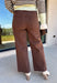 These chocolate brown jeans from Just Black Denim are the perfect blend of timeless style and everyday versatility. Designed with a flattering slim wide leg silhouette, they create an effortlessly elevated look that's easy to dress up or down. The rich chocolate brown color offers a fresh alternative to traditional denim, while the raw edge hem adds a modern finishing touch. Crafted with just the right amount of stretch for all-day comfort, these jeans are sure to become a staple in your fall wardrobe.