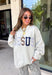 Wear your faith in the coziest way with this heather grey “Jesus” pullover from Bucket List. Each letter features its own unique print, including dainty florals, classic stripes, plaid, and solid navy in a soft mix of neutrals and shades of blue. Light grey embroidery outlines each letter for an extra touch of texture that makes the design stand out beautifully against the heather grey background. 