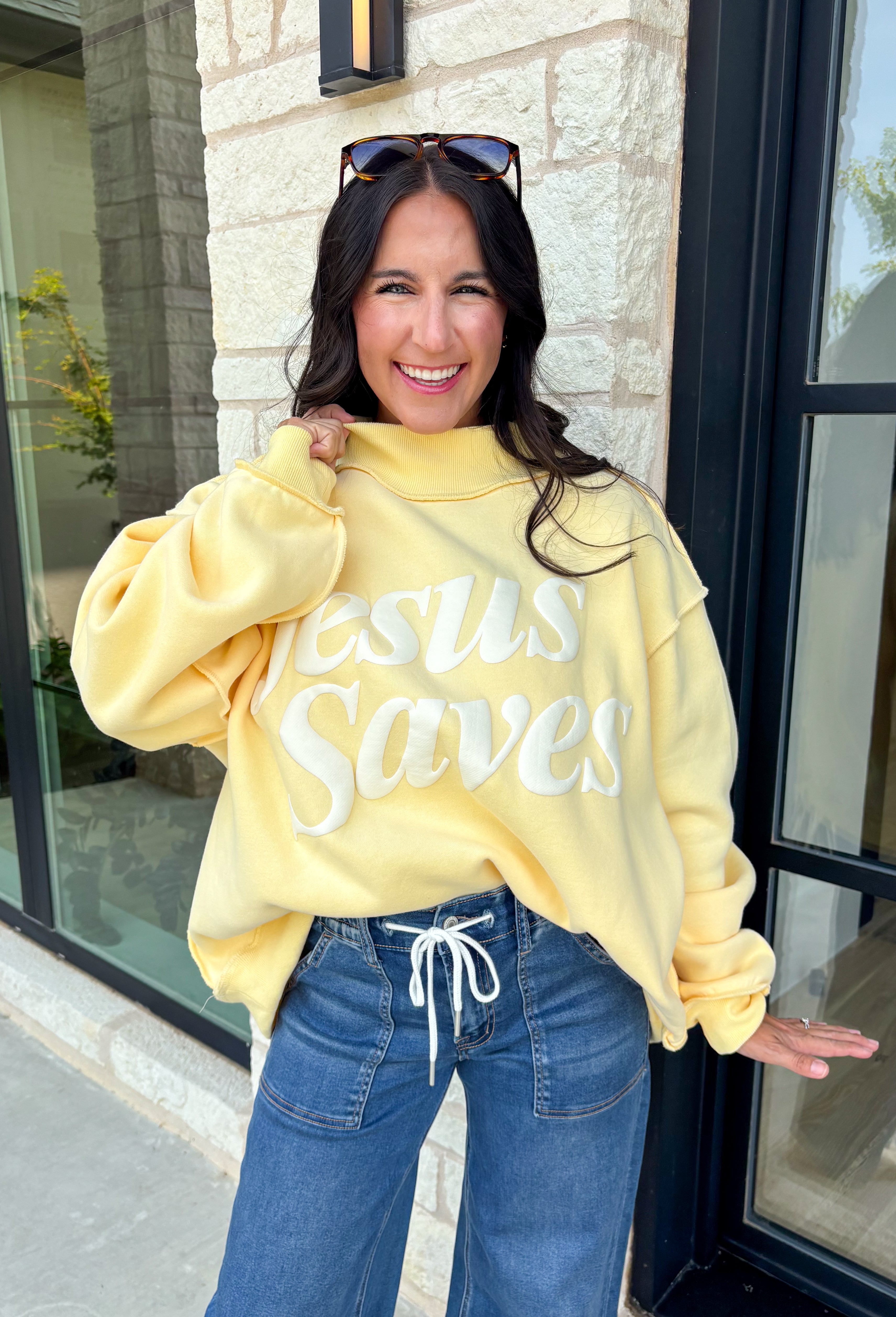 Wrap yourself in faith and comfort with this butter yellow pullover that shares a message worth wearing! Featuring cheerful bubble lettering that reads "Jesus Saves," this cozy soft sweatshirt is the perfect reminder of hope and grace wherever your day takes you. The fleece-lined interior keeps you warm and cozy, while the exposed seam details and ribbed trim give it a laid-back, lived-in feel. 